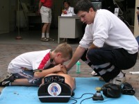 Foto: Der Zivilschutz zeigt einem Jungen an einer Puppe wie man eine Person wiederbeatmen kann.